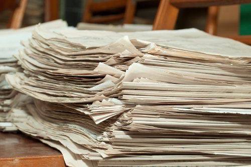 Stack of paper documents as a metaphor for messy documentation